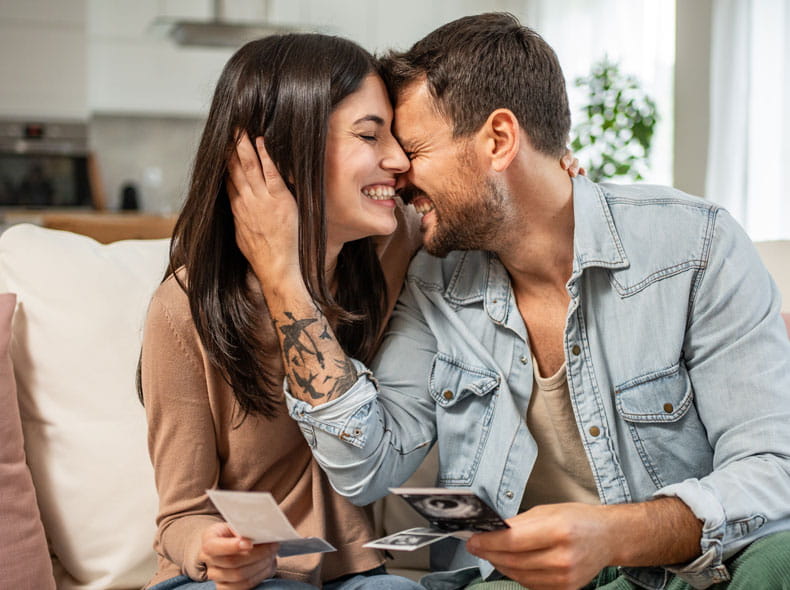 man and woman celebrating a pregnancy