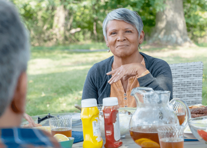 Senior woman enjoying a picnic outside