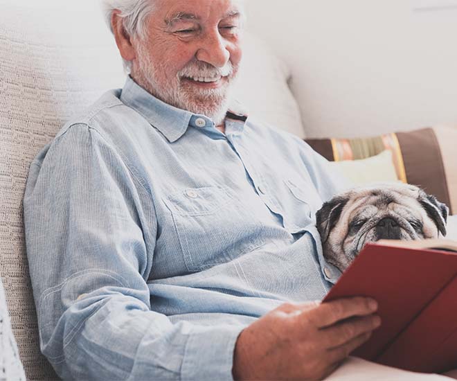 Man on couch reading a book