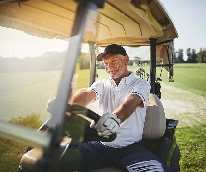 man in a golf cart smiling