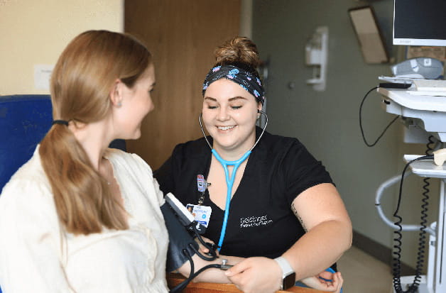 A nurse takes a patient's blood pressure