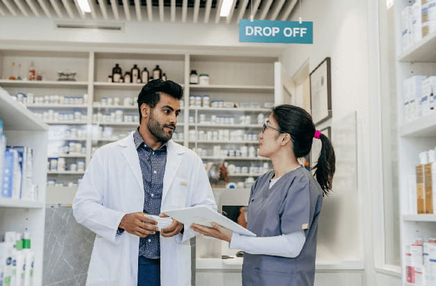 Pharmacist and team busy filling prescriptions