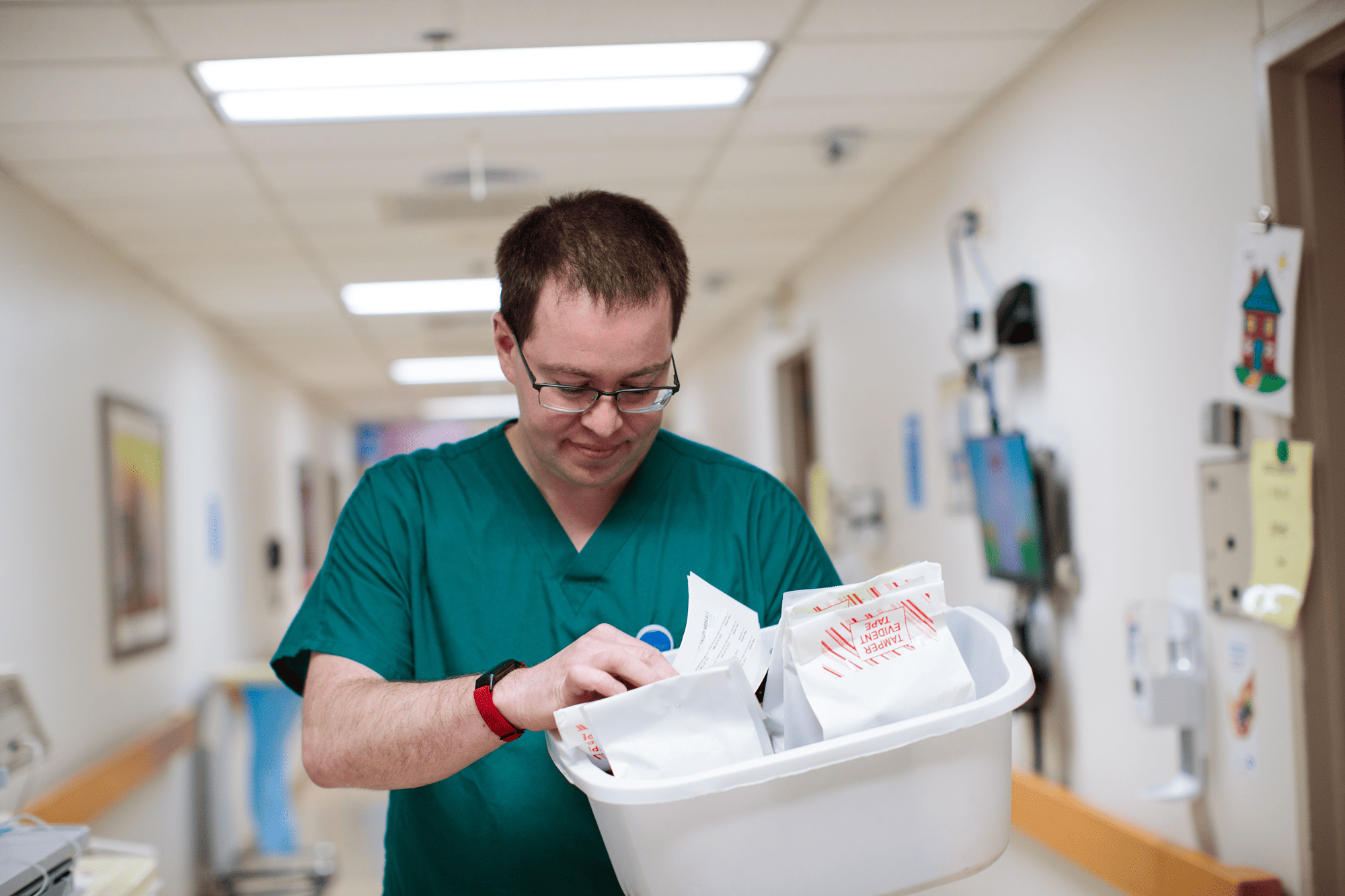 A nurse holding a box of prescription bags