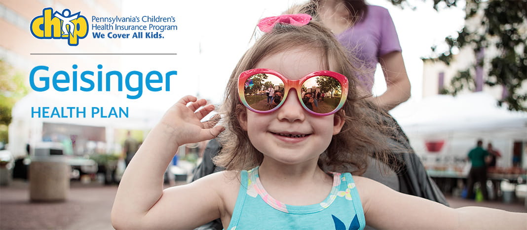 Smiling little girl wearing sunglasses in a stroller