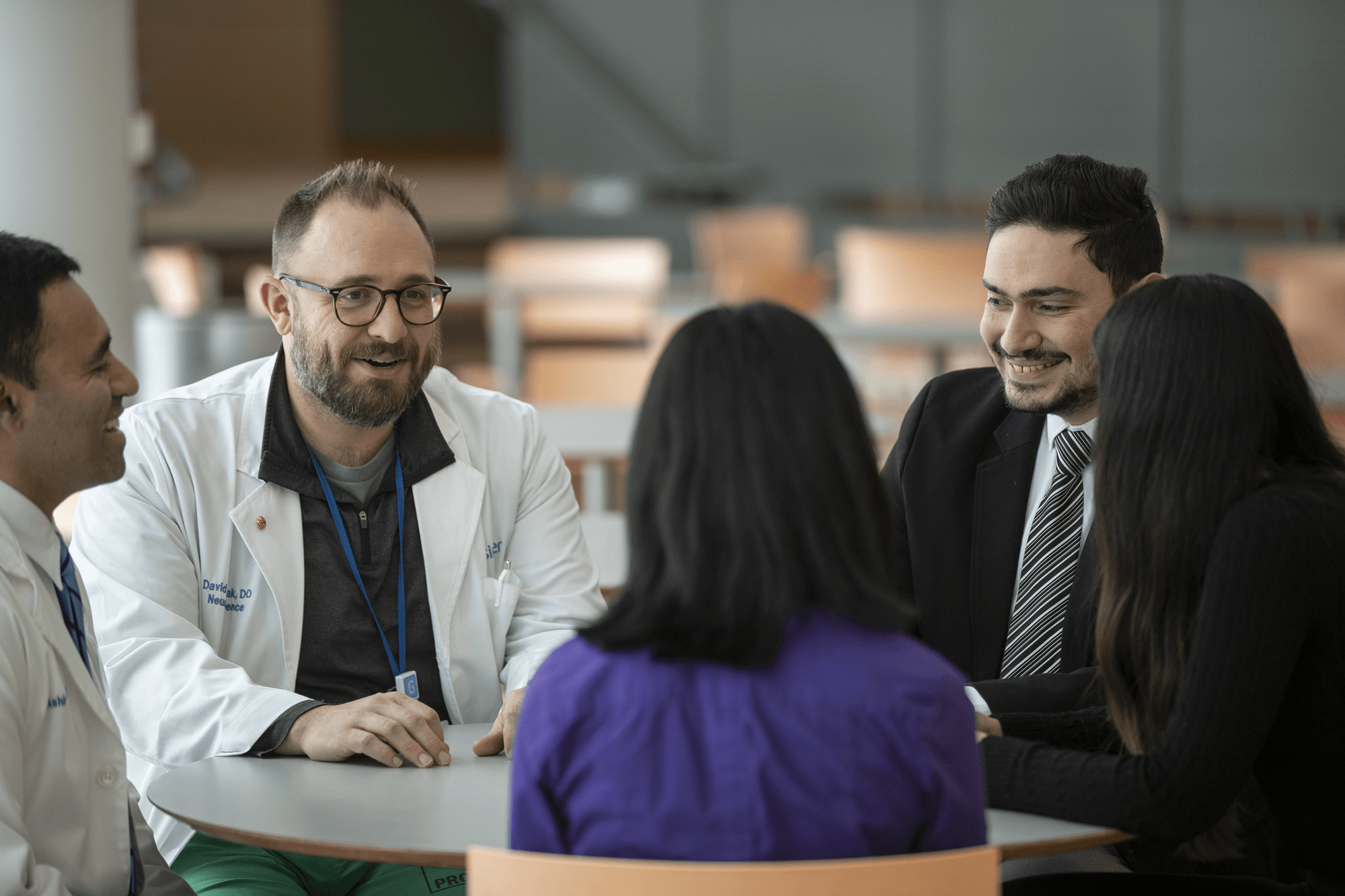 A group of hospital employees chat in the cafeteria