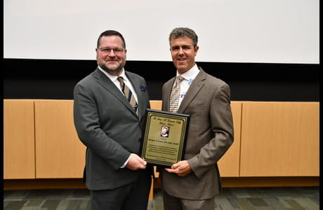 Mike Evans receives an award from Larry Jones