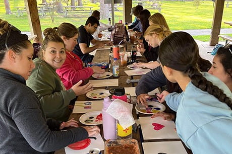 an image of students painting at the wellness dy event