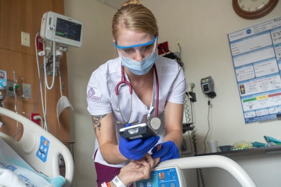 An image of a student helping a patient