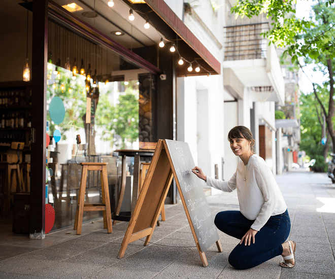 Shop owner updating chalkboard