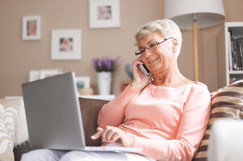 Older woman on laptop and phone