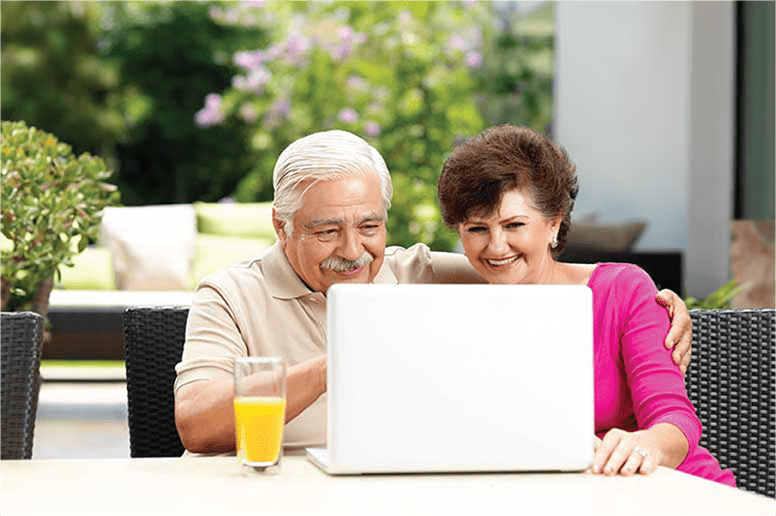 Couple on laptop to shop for medicare plan and enroll in medicare.