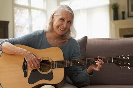 A Medicare Advantage member playing the guitar