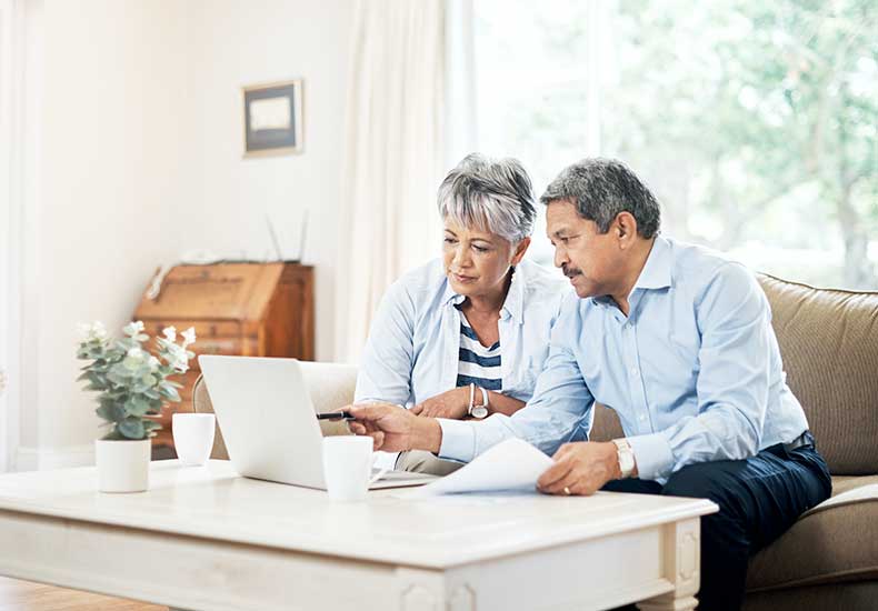 an elderly couple browsing Medicare plans online
