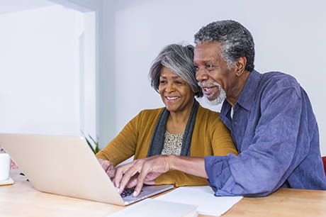 Senior couple sitting together on the computer