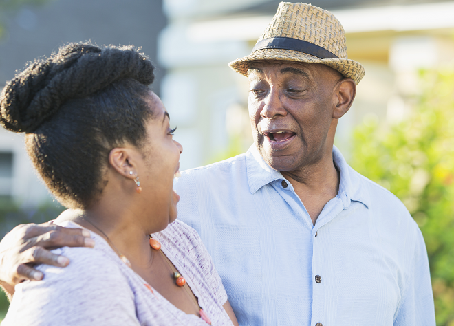 Senior couple laughing outside
