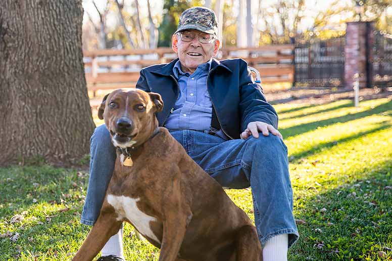 A retired U.S. veteran relaxes with his dog.