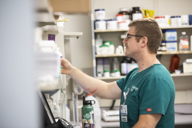 an image of a pharmacist filling a precription