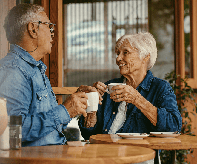 Senior couple smiling at a cafe