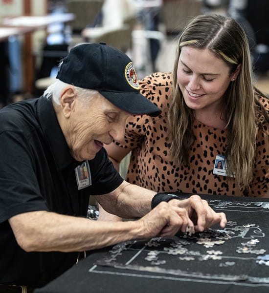 A LIFE Geisinger program member assembles a puzzle in her home.