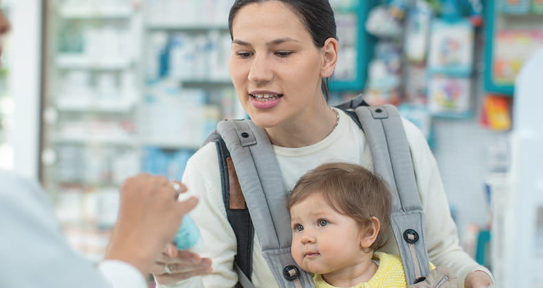 an image of a mother with a baby at the pharmacy