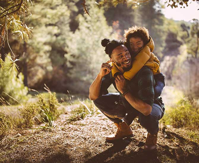 an image of a dad and his toddler hiking