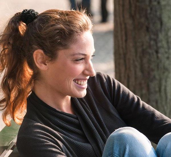 woman smiling by tree