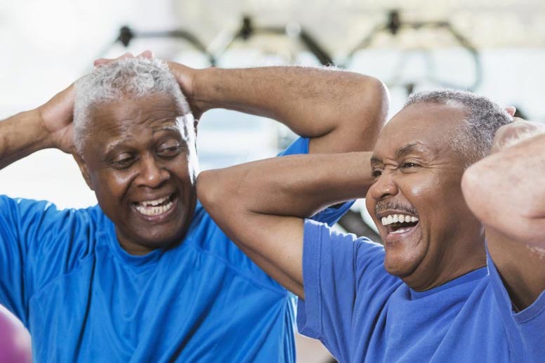 a caregiver and senior man working out together