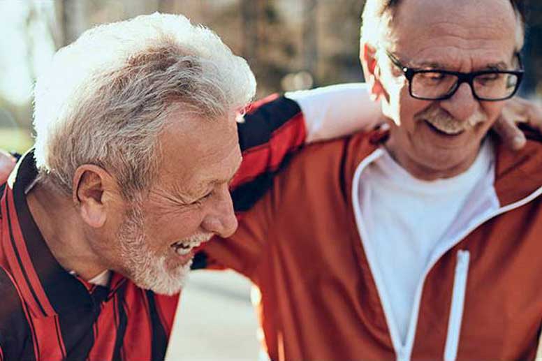 two senior men having fun playing soccer