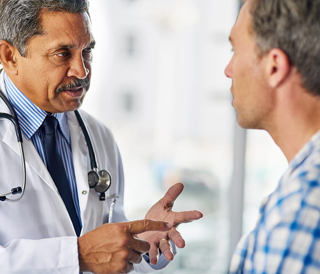 Male doctor talking to male patient