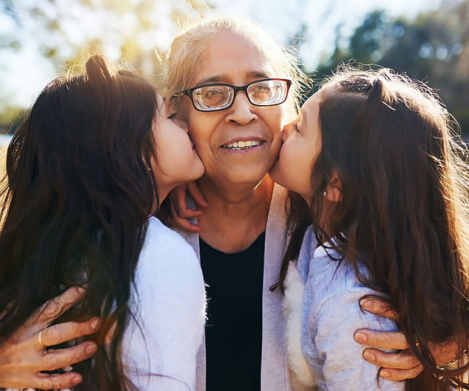 Grandmother celebrating with her granddaughters after successful gallblader surgery.
