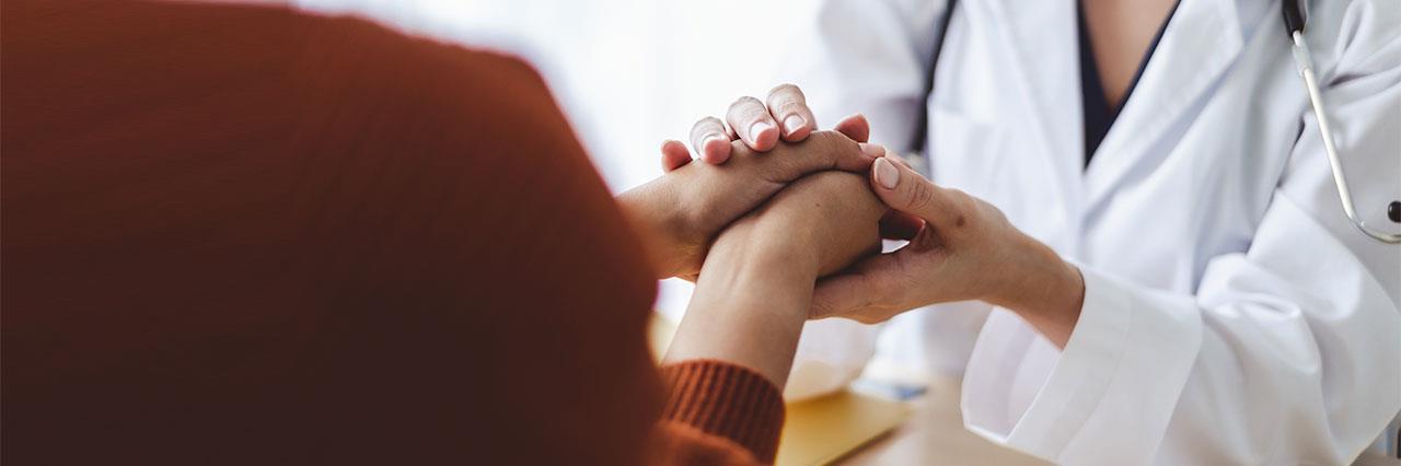 doctor woman holding patient's hand