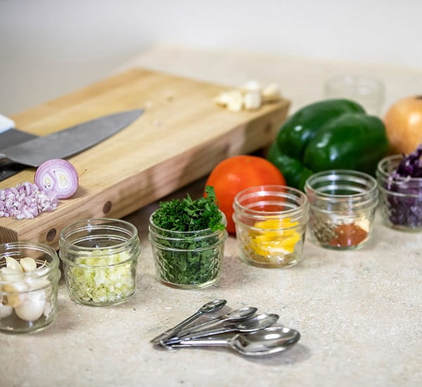 An assortment of fresh fruits and vegetables arranged in a crate.