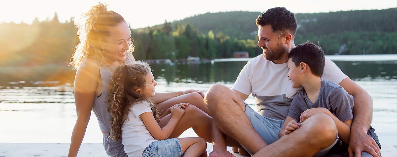 family of four with diabetic child sharing a special moment on the dock