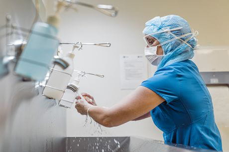 Nurse washing hands with mask in hospital 