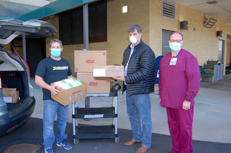 masked people donating food