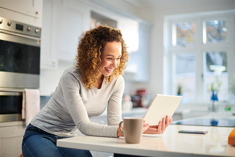 woman video chatting online in her kitchen