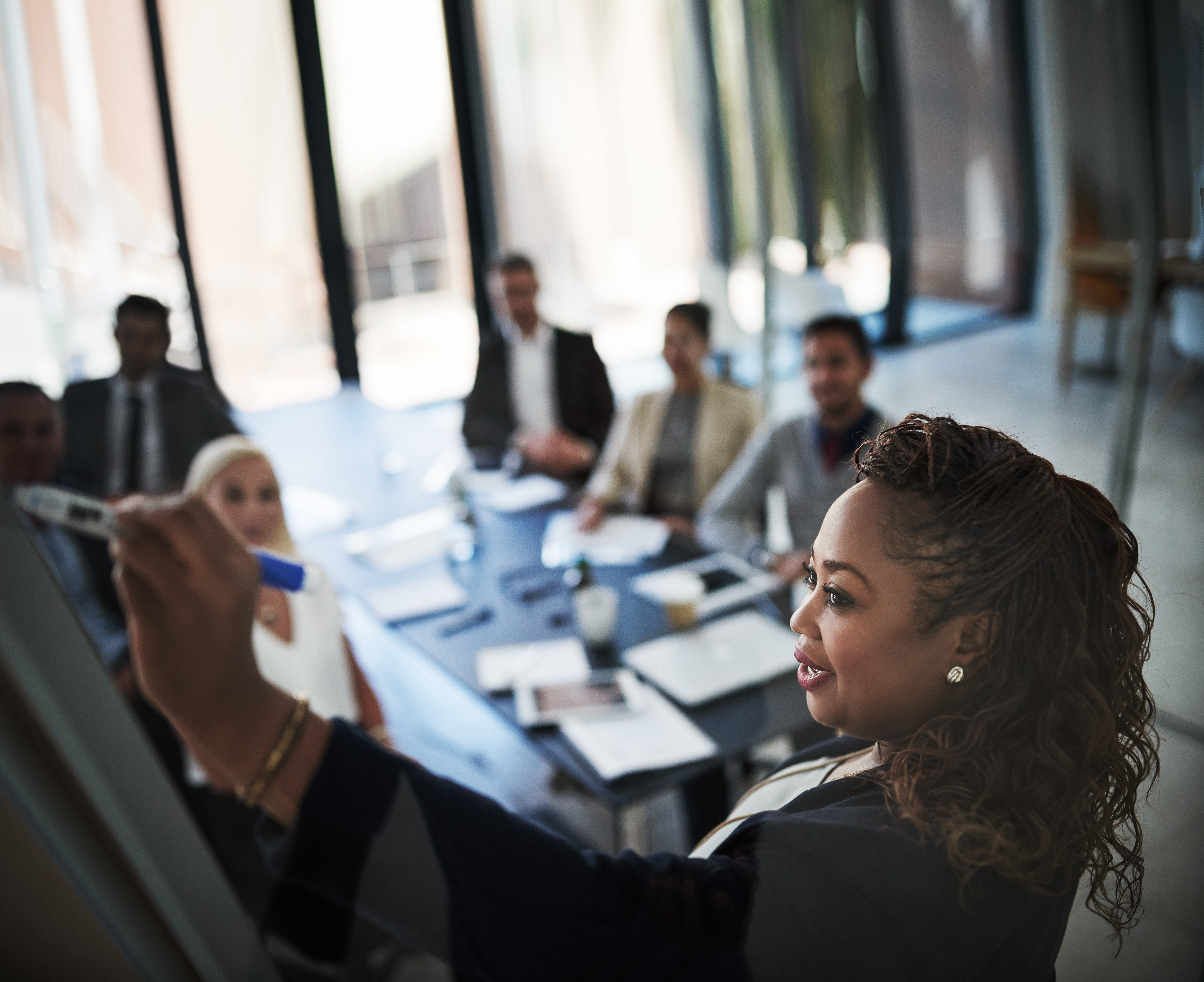 Image of a meeting being lead by a female