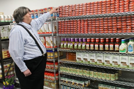 Tom looks at items on a shelf at the Fresh Food Farmcay