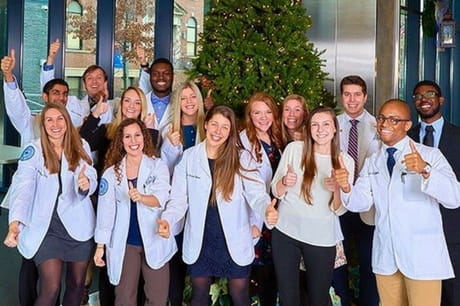 Students from Geisinger Commonwealth School of Medicine give a thumbs up.