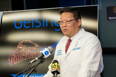 Dr. Michael Suk talks at a news conference