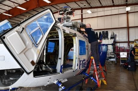 Life Flight maintenance team member working on a helicopter.
