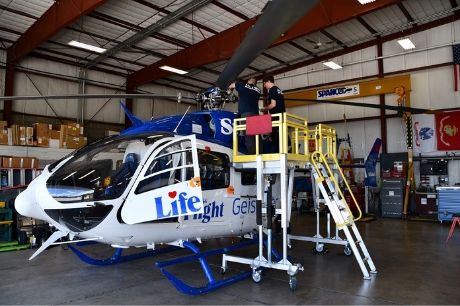 Life Flight maintenance team members working on a helicopter.