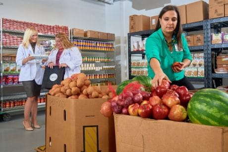 Geisinger Fresh Food Farmacy staffers organize and discuss fruits and vegetables.