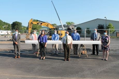 Medical staff from Geisinger Lock Haven gather at the steel beam they signed at the Geisinger Medical Clinic Lock Haven construction site.