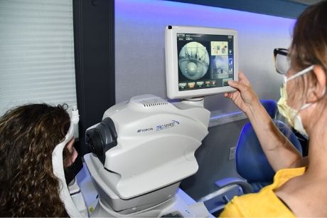 A woman has her eyes examined on Geisinger's mobile health services bus.