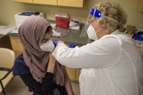 Resident physician Sayeda Abbas receives the second dose of the COVID vaccine.