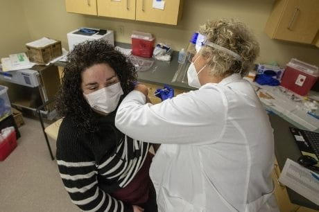 Nurse Tara Skutack receives the second dose of the COVID vaccine.