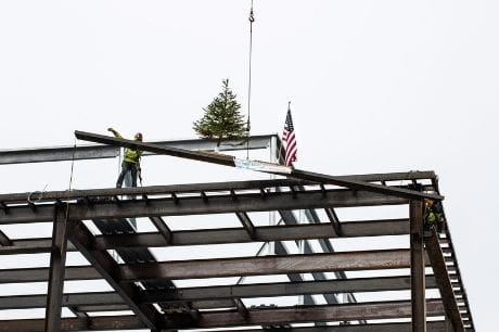 Construction crews place the final steel beam at Geisinger Medical Center Muncy.