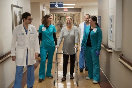 Surgery patient Roseanne Hartland with Dr. John J. Mercuri and physical therapy team.