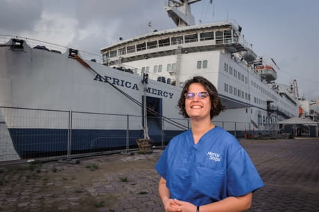 Geisinger nurse Cathrine Fultz in front of the ship Africa Mercy
